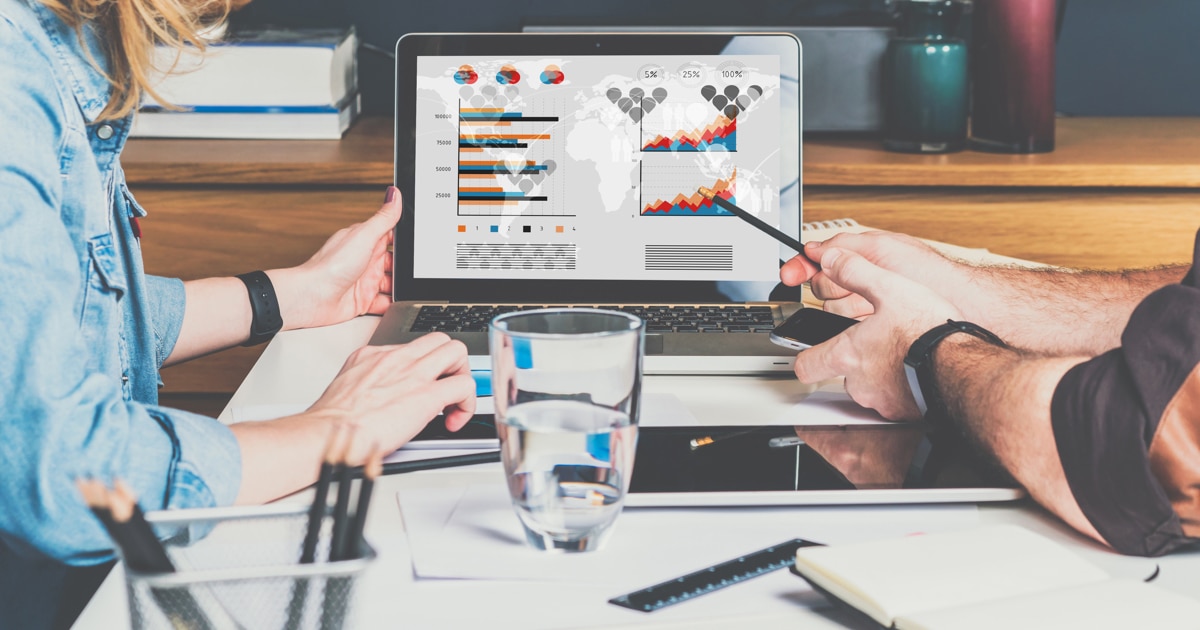 Marketing analysts looking at a graph while building a report